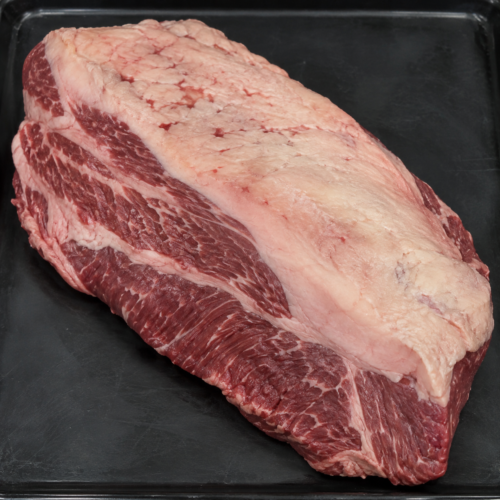 Illustrative image of raw beef brisket on a black butcher’s tray