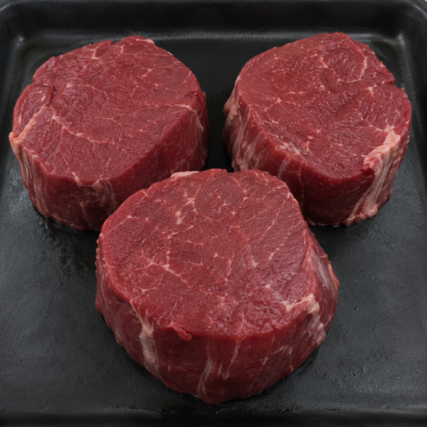 Illustrative image of raw fillet steaks on a black butcher’s tray